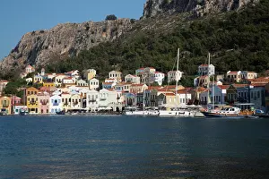 Navigation Prints: View of boats anchored in Megisti Bay with houses lining the harbor in Kastellorizo