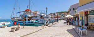 Holiday Destination Prints: View of boats and cafes in the harbour in Gaios Town
