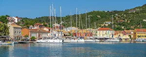 Blue Water Prints: View of boats and colourful buildings in the harbour in Gaios Town