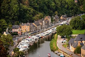 Docked Prints: View of boats docked along the River Rance near buildings in historic town of Dinan in Brittany France