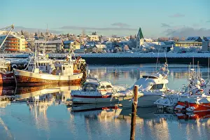 Cozy Prints: View of boats in Hafnarfjorour Marina and town in background in winter