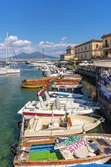 Vesuvius Prints: View of boats in harbour, restaurants and Mount Vesuvius from Ovo Castle