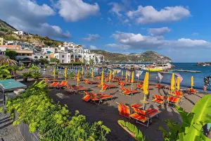 Azure Waters Prints: View of brightly coloured loungers on the beach and Sant'Angelo from Porto di Sant'Angelo