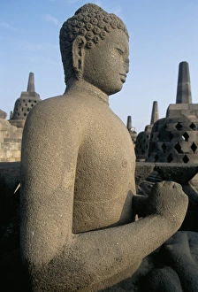 Borobodur Prints: Side view of Buddha image sitting in open chamber with