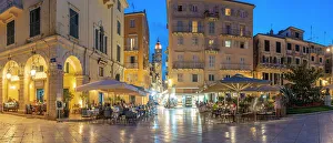 Outdoor Seating Prints: View of buildings and restaurants on Kofineta Square at dusk
