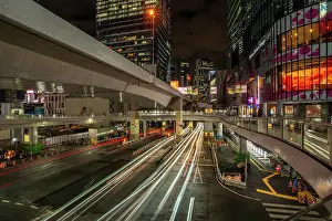 Pedestrians Prints: View of buildings and trail lights around Shibuya Station area at night