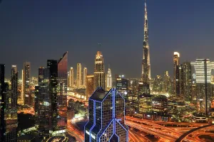 Crowded Prints: View of Burj Khalifa and Dubai skyline at night with city lights and busy roads in central Dubai