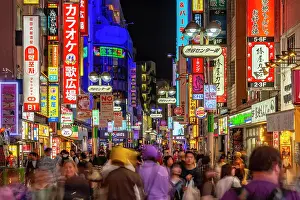Shibuya Prints: View of busy street and neon lights at night in Shibuya District