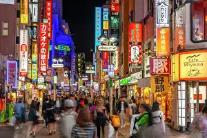 Pedestrians Prints: View of busy street and neon lights at night in Shibuya District