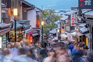 Bustling Prints: View of busy street and traditional wooden houses and shops in Gion