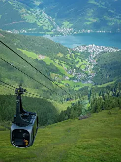 Riding Prints: View of cable car heading over Zell am See from Schmittenhohebahn top station on a sunny day in Salzburg