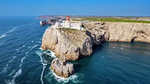 Bright Prints: View of Cabo de Sao Vicente lighthouse standing on the cliffs above the Atlantic Ocean in Sagres Algarve Portugal