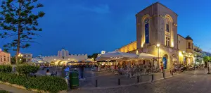 View of cafe and restaurant in Eleftherias Central Square in Kos Town at dusk, Kos, Dodecanese, Greek Islands, Greece, Europe