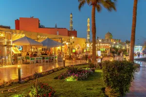 Hedge Prints: View of cafe and restaurant in Hurghada Marina and Al Mina Mosque in background at dusk