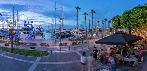 Kos Town Prints: View of cafes and boats in Kos Harbour at dusk