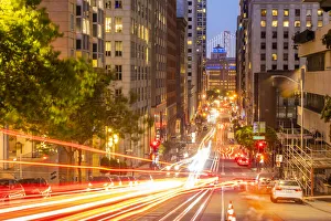 Tail Light Prints: View of California Street and Oakland Bay Bridge at dusk, San Francisco, California