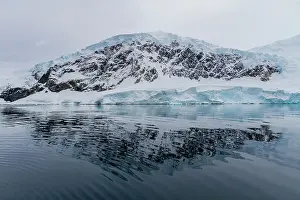 Ocean View Prints: View of calm seas and reflected mountains surrounding Neko Harbor on the western side of the Antarctic Peninsula
