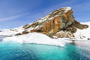 Blue Water Prints: View of calm seas and reflected mountains surrounding Paradise Bay on the western side of the Antarctic Peninsula