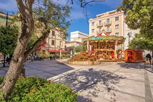Water Fountain Prints: View of carousel and fountain on Piazza Matteotti on sunny day in Olbia