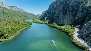 Flowing Prints: View of the Cetina gorge and river with boat navigating through water in Croatia