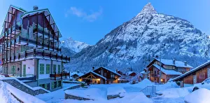 Reflective Prints: View of chalets and snow covered mountains in Courmayeur before dawn in winter