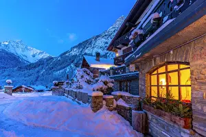 Chalet Prints: View of chalets and snow covered mountains in Courmayeur before dawn in winter
