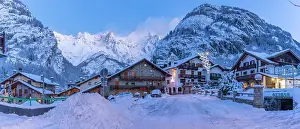Chalets Prints: View of chalets and snow covered mountains in Courmayeur before dawn in winter