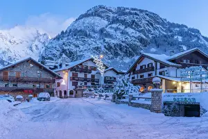 Chalets Prints: View of chalets and snow covered mountains in Courmayeur before dawn in winter
