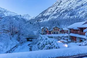 Cottages Prints: View of chalets and snow covered mountains in Courmayeur before dawn in winter