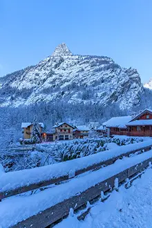 Chalets Prints: View of chalets and snow covered mountains in Courmayeur before dawn in winter
