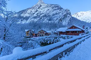 Cabins Prints: View of chalets and snow covered mountains in Courmayeur before dawn in winter