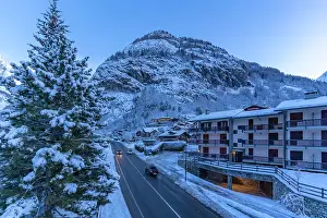 Chalets Prints: View of chalets and snow covered mountains in Courmayeur before dawn in winter