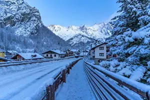 Cabin Prints: View of chalets and snow covered mountains in Courmayeur before dawn in winter