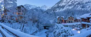 Chalets Prints: View of chalets and snow covered mountains in Courmayeur before dawn in winter