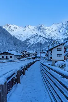 Chalets Prints: View of chalets and snow covered mountains in Courmayeur before dawn in winter