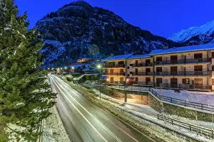 Cabin Prints: View of chalets and snow covered mountains in Courmayeur at dusk in winter