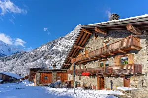 Chalets Prints: View of chalets and snow covered mountains in Courmayeur at sunrise in winter