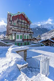 Chalets Prints: View of chalets and snow covered mountains in Courmayeur at sunrise in winter