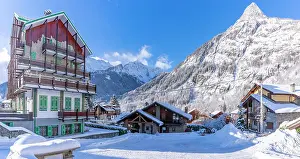 Cabin Prints: View of chalets and snow covered mountains in Courmayeur at sunrise in winter