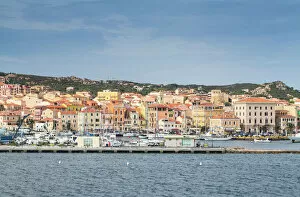 Typically Italian Gallery: View of the characteristic harbour and blue sea of Caprera, La Maddalena Island, Sardinia