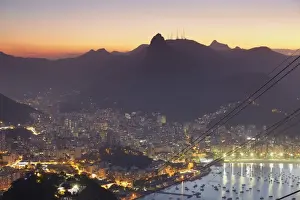 Christ The Redeemer Prints: View of Christ the Redeemer statue and Botafogo Bay at sunset from Sugar Loaf Mountain