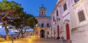 Lamps Prints: View of Church of Our Lady of Grace at dusk in the Alfama District