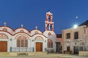 Charm Prints: View of Church of the Metamorphosis of the Savior in Piskopiano village at dusk with warm lights and moon overhead