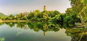 Bells Prints: View of church reflecting in Karavomilos Lake in Sami