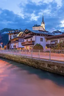 Waterscape Prints: View of church along river in Kaprun during dusk in summer with clouds in the sky