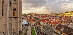 Panoramas Prints: View of city rooftops and Carmo Archaeological Museum from Santa Justa Lift during golden hour