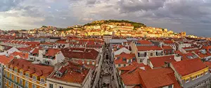 Enchanting Prints: View of city rooftops and Lisbon Castle from Santa Justa Lift during golden hour