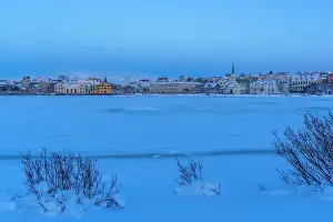 Chill Prints: View of the city skyline of Reykjavik from Tjornin lake at sunset in winter