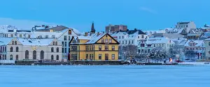 Tjornin Prints: View of the city skyline of Reykjavik from Tjornin lake at sunset in winter