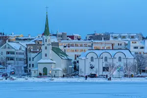 Mood Prints: View of the city skyline of Reykjavik from Tjornin lake at sunset in winter